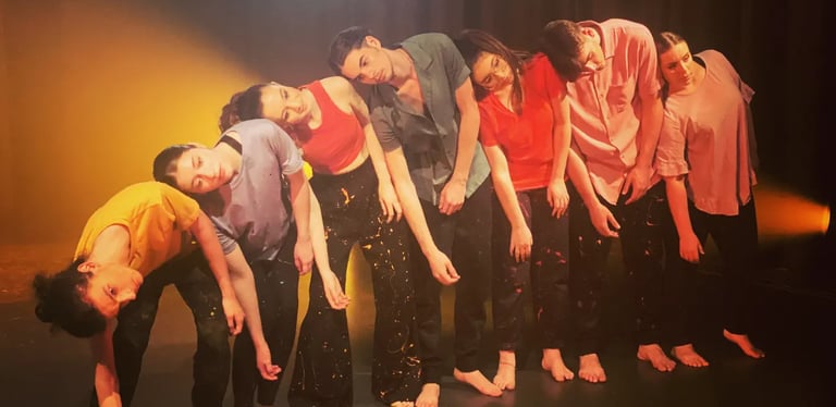 a group of people standing in a line of dancers