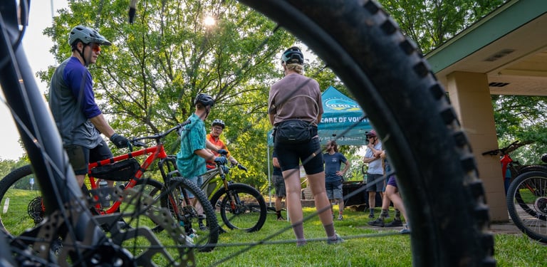 People on bikes in the background of a photo with the focus on a bike tire
