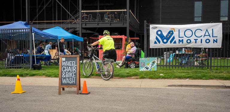 Photo of the event in the Logboat green area with the "Wheelchair & Bike Wash" sign in the road