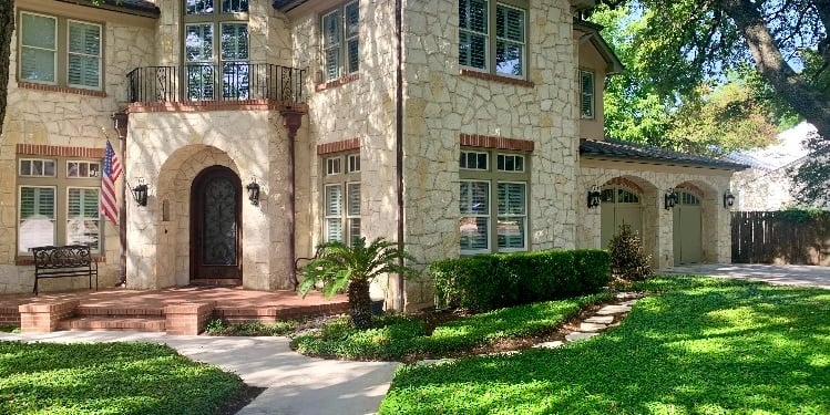 Stone mansion with arched windows under oak trees, Elegant Restorations San Antonio