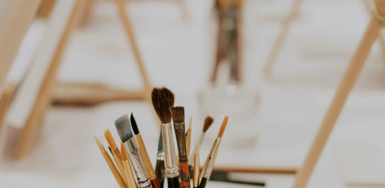Pinceau posé à côté des toiles de peinture 