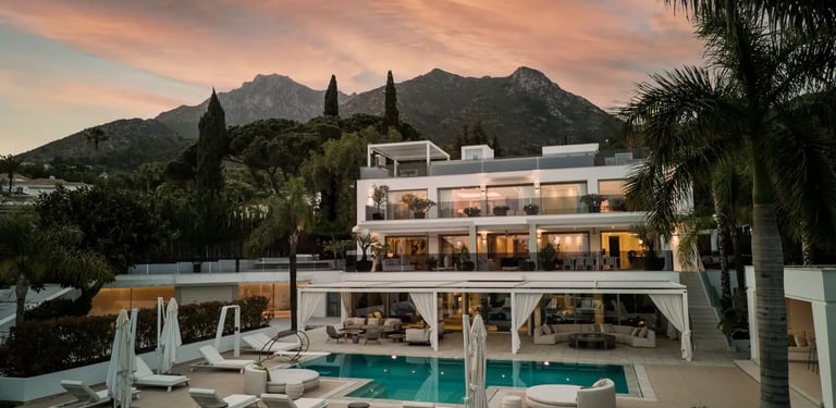 Sunset view of Villa Serenity exterior with pool and gardens