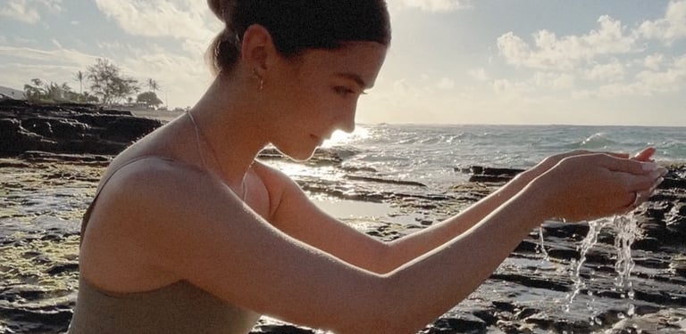 Girl at beach holding water