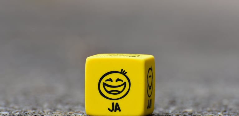 a yellow dice game dicer with a smiley face