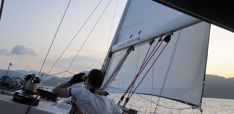 a man in a white shirt is sitting on a boat. Copyright Vincent Volpe