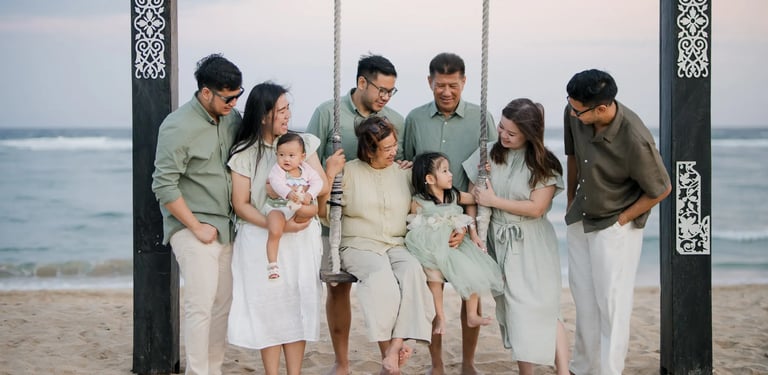 Multigenerational family gathered beneath a beach pavilion during a family photography session in Nusa Dua Bali.
