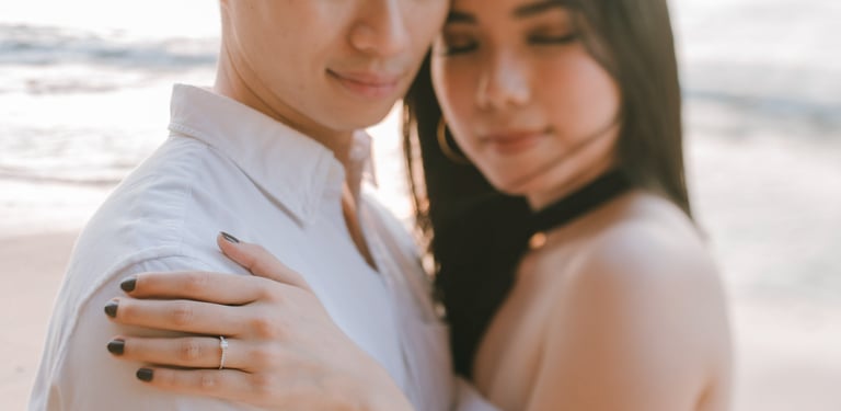 Close couple embrace during a sunset proposal photography session at Anantara Uluwatu Bali Resort.