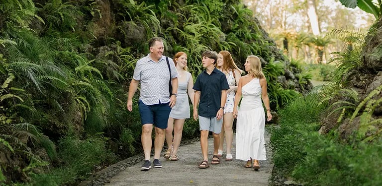 Family walking together through the tropical gardens at AYANA Resort Bali