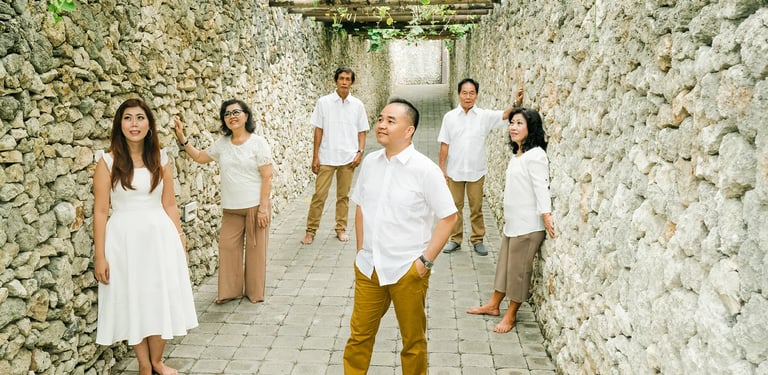 Selly family  through the stone pathway during a luxury family photography session at Karma Kandara Uluwatu Bali  