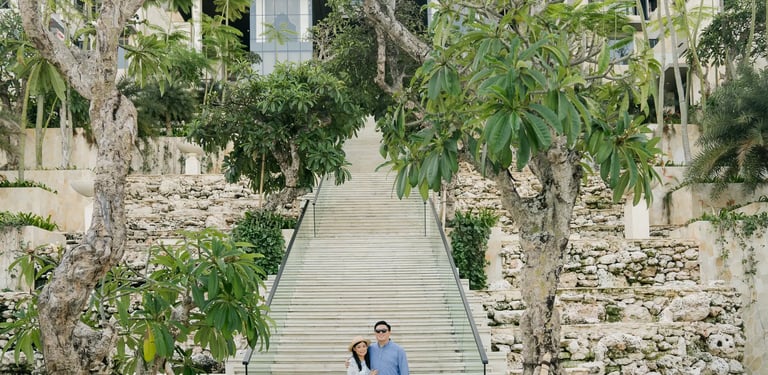 Couple standing on the iconic Grand Staircase at The Apurva Kempinski Bali