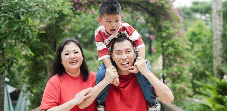 father carrying child on shoulders during a relaxed family photography session at Movenpick Jimbaran Bali