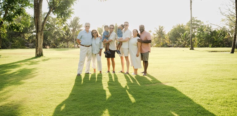 multi generation family walking together on the lawn at rimba by ayana bali during a relaxed bali family photography session