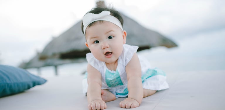 Baby crawling on daybed during family photography session at Sofitel Nusa Dua Bali