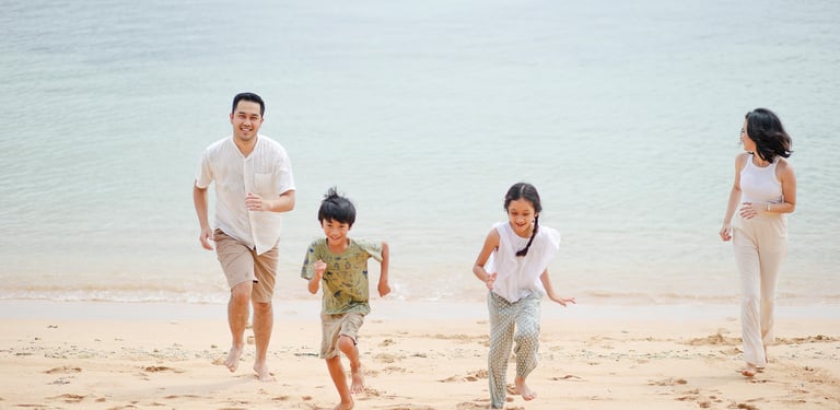 family walking together during beach session at Westin Nusa Dua Bali