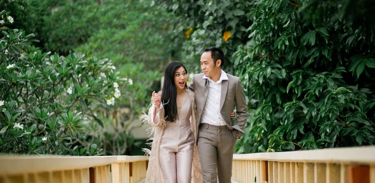 Romantic prewedding couple walking on garden bridge at Amankila Karangasem
