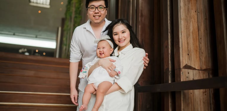 Multigeneration family portrait at Alila Seminyak Bali with parents holding their baby during a relaxed luxury family session