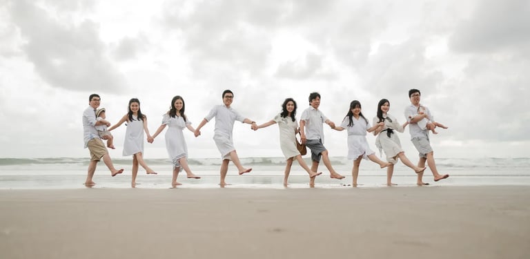 Multigeneration family running together at Bali beach during joyful and candid family photography session.
