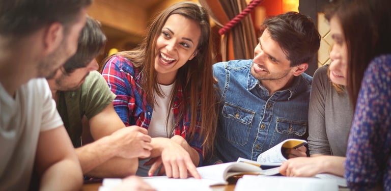 A group of students sitting together, studying or working on a project, representing the students