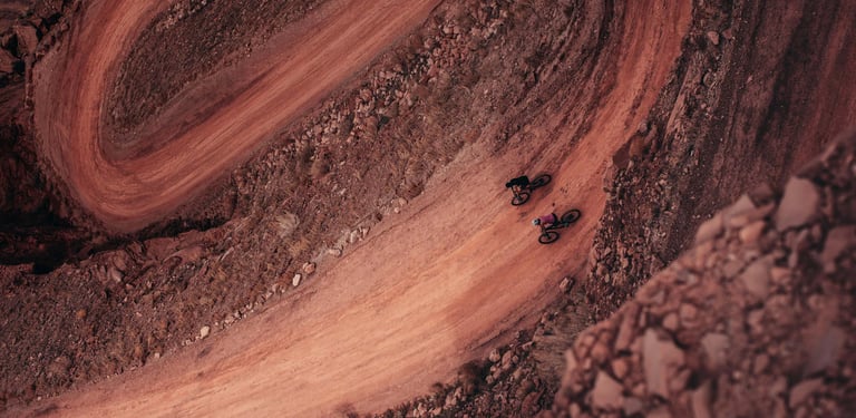 a person riding a bike on a dirt road