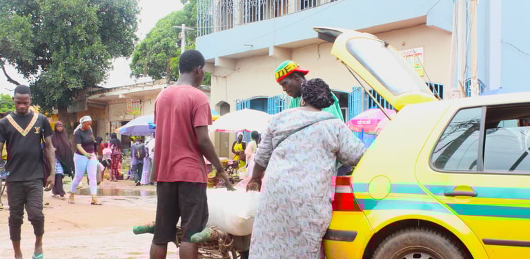 a seller negotiating price with taxi driver in The Gambia