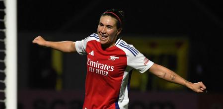 a woman soccer player is celebrating a goal