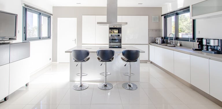 a kitchen with a bar stool and bar stools