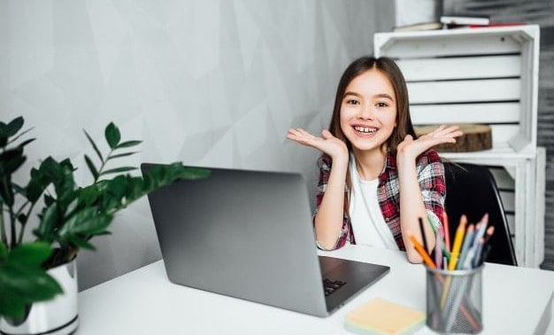 Student enjoying online maths tutoring on laptop