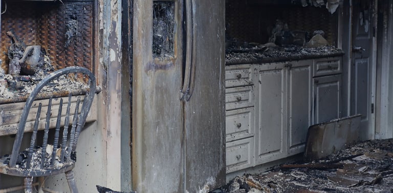 alt="Severe fire and smoke damage in Long Island kitchen with burned cabinetry"