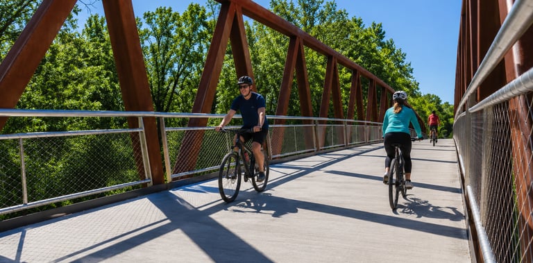 Cyclists riding across a bridge on the Louisville Loop in Kentucky
