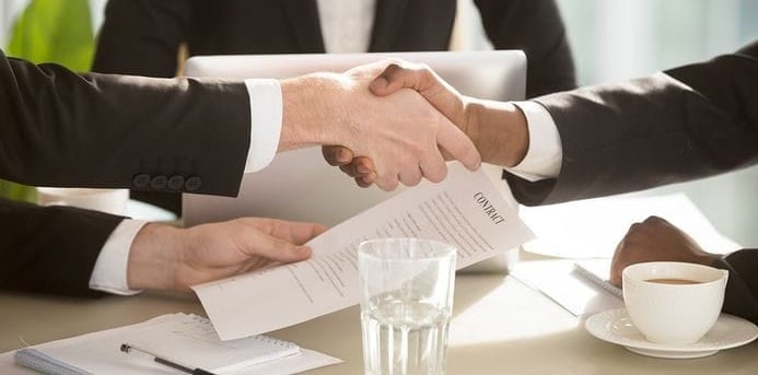 a business meeting with a handshake of two people