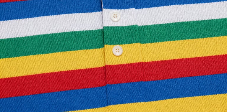 Close-up of a vibrant multi-colored striped polo shirt fabric texture.