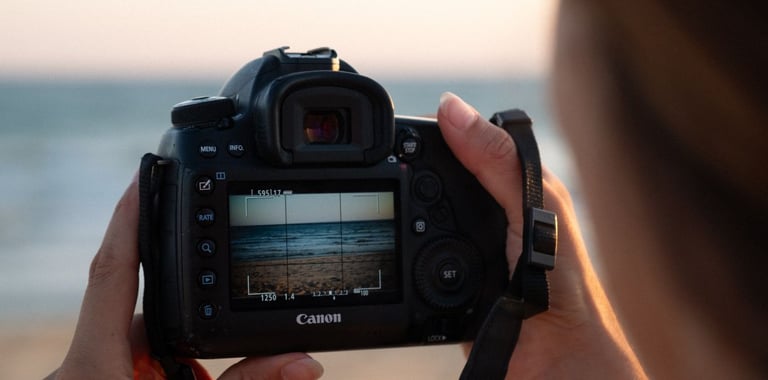 a person holding a camera and taking a picture of a camera