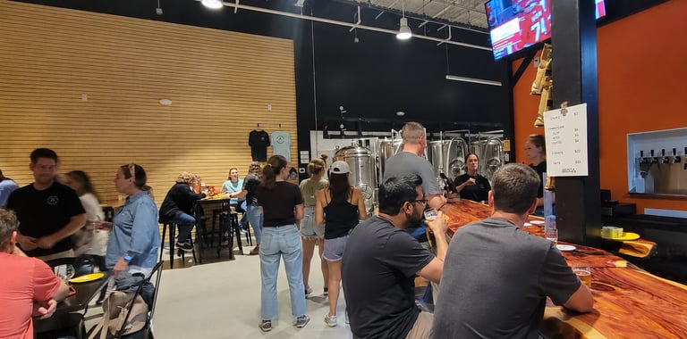 Crowd of people enjoying craft beer at sneaky penguin brewing