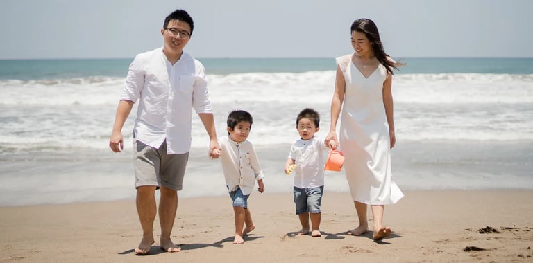 Andi family walking together during a natural beach family session at W Bali Seminyak