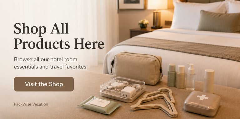 Travel essentials and hotel room accessories including toiletries and chargers on a bed.