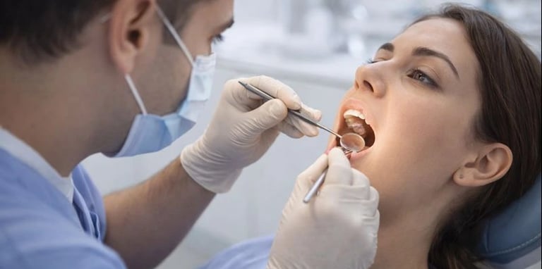 Dentist examining a problematic wisdom tooth during dental check-up