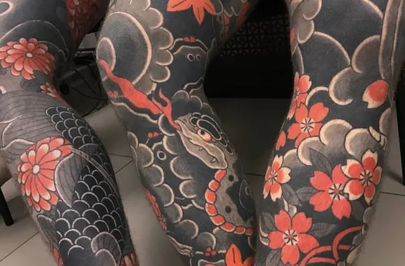 a woman with tattoos on her leggings and leggings