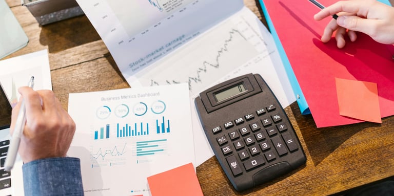 calculator and charts representing business and consulting