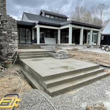 a house with a concrete patio and stairs