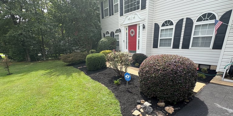 Mulch and decorative rock bed installation with custom flower bed design and edging for a Southern M
