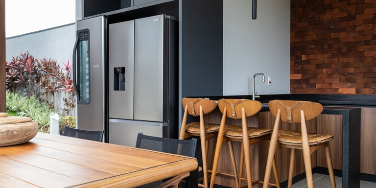 a kitchen with a table and chairs and a bowl of fruit