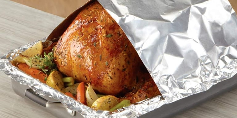 a turkey roasting turkey in foil