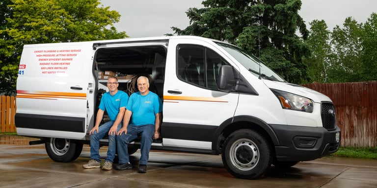 John and Dave sitting in their service truck