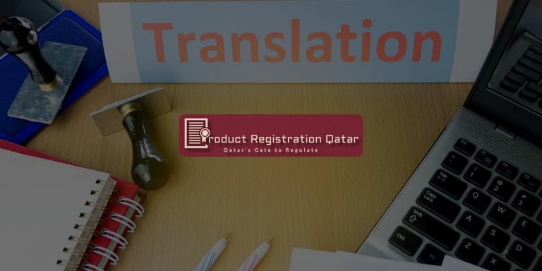 Desk with translation stamp, notebook, and a laptop beside a sign labeled "Translation" + Product Registration Qatar Logo
