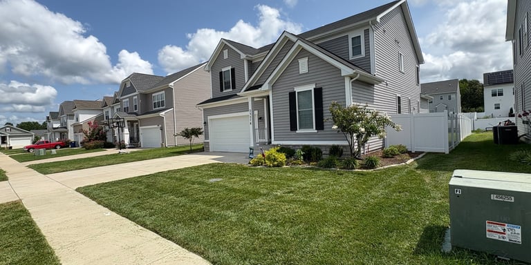 Freshly mowed residential lawn in Southern Maryland with weekly and biweekly lawn care, hedge trimmi