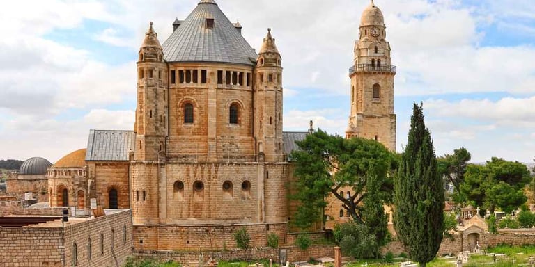 Dormition Abbey at Mount Zion, Jerusalem against a cloudy blue sky