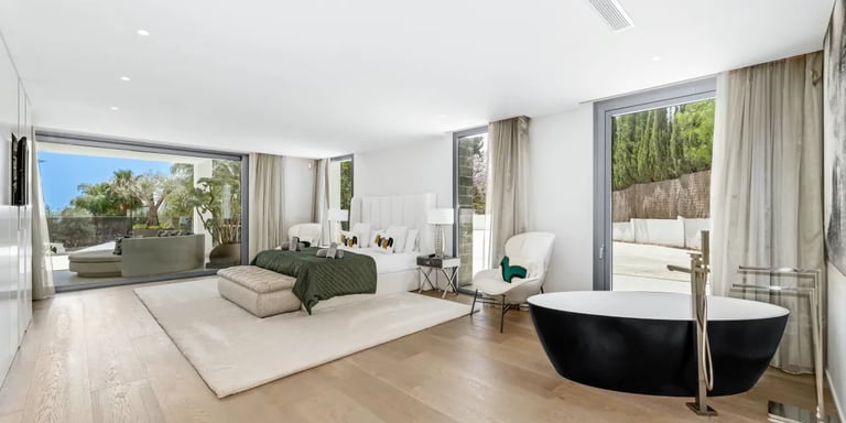 Villa Serenity suite with freestanding black tub and terrace view