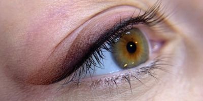 a close up of a person's eye with a brown eye