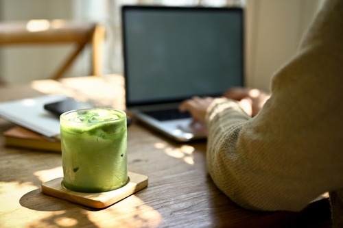 a person sitting at a table with a drink