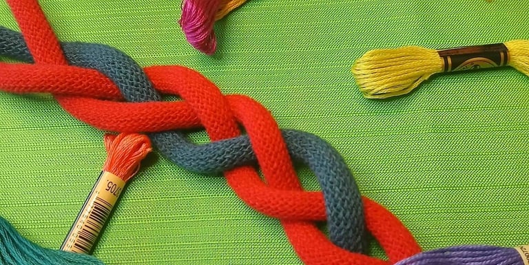 a bunch of thread - wrapped thread threads and scissors
